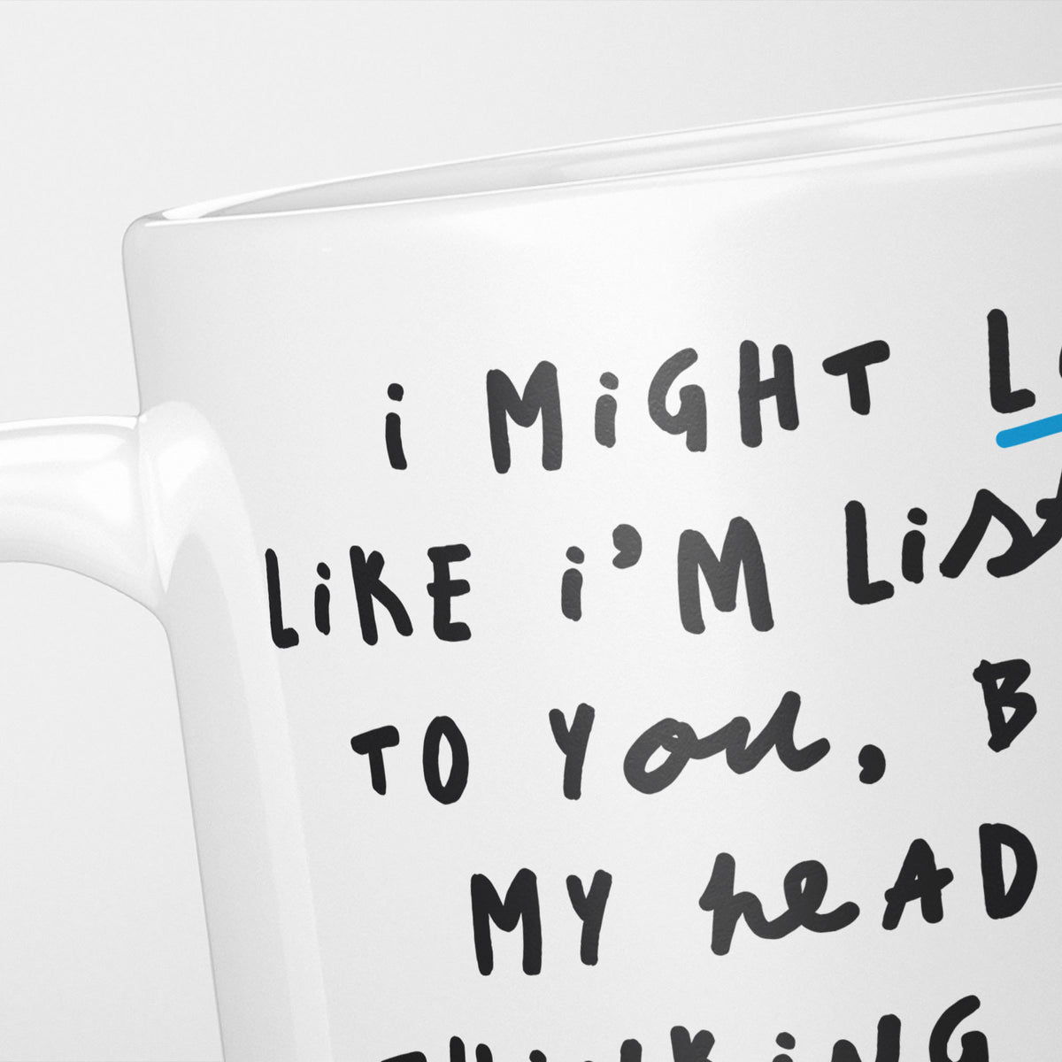 Close crop of the I'm Thinking About Fantasy Football mug, the opening of the hand-lettered text running off the frame, underlined in blue