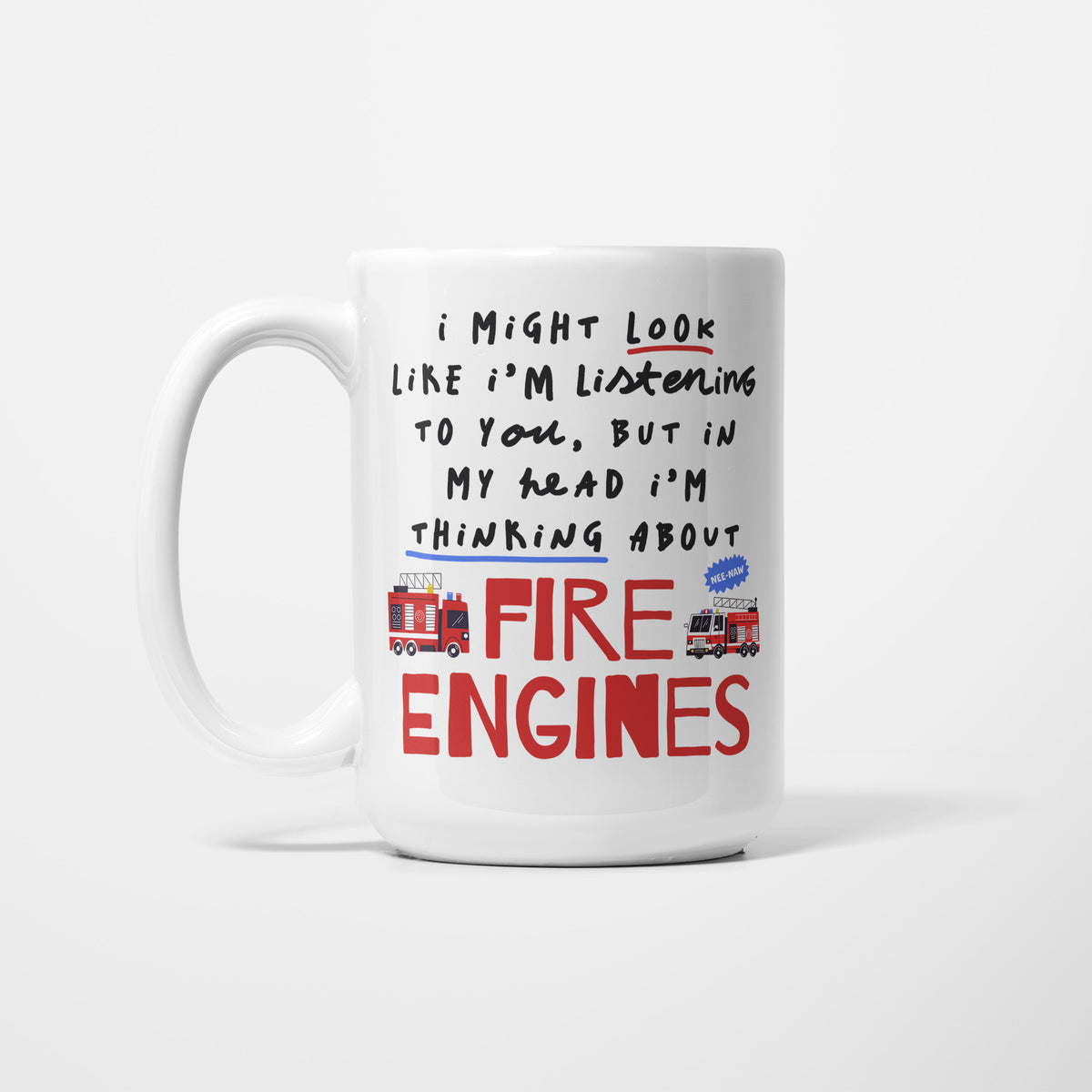 Left side of a white 15oz ceramic mug, hand-lettered "I might look like I'm listening to you, but in my head I'm thinking about Fire Engines" in red, illustrated with two red fire engines and a blue NEE-NAW starburst