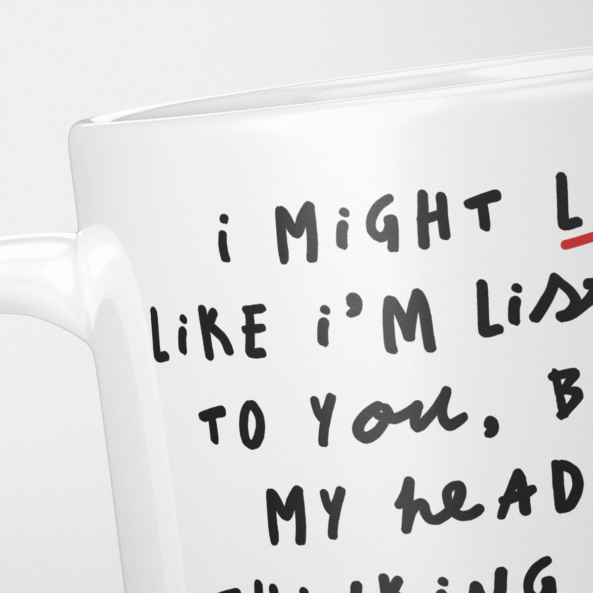 Close crop of the I'm Thinking About Fire Engines mug, the opening of the hand-lettered text running off the frame, underlined in red