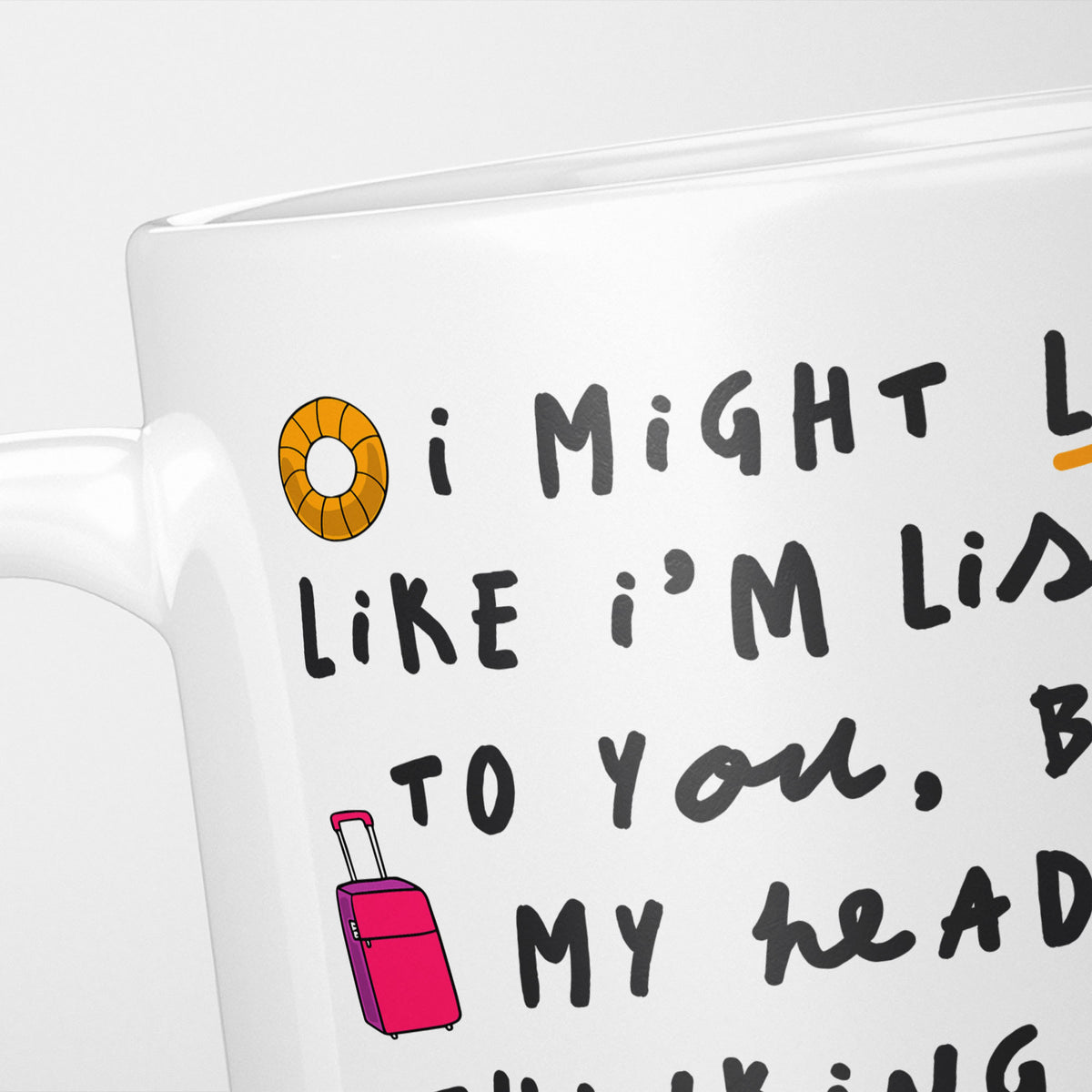 Close crop of the I'm Thinking About Booking a Holiday mug, the opening of the hand-lettered text underlined in orange, with a rubber ring and a pink wheeled suitcase alongside