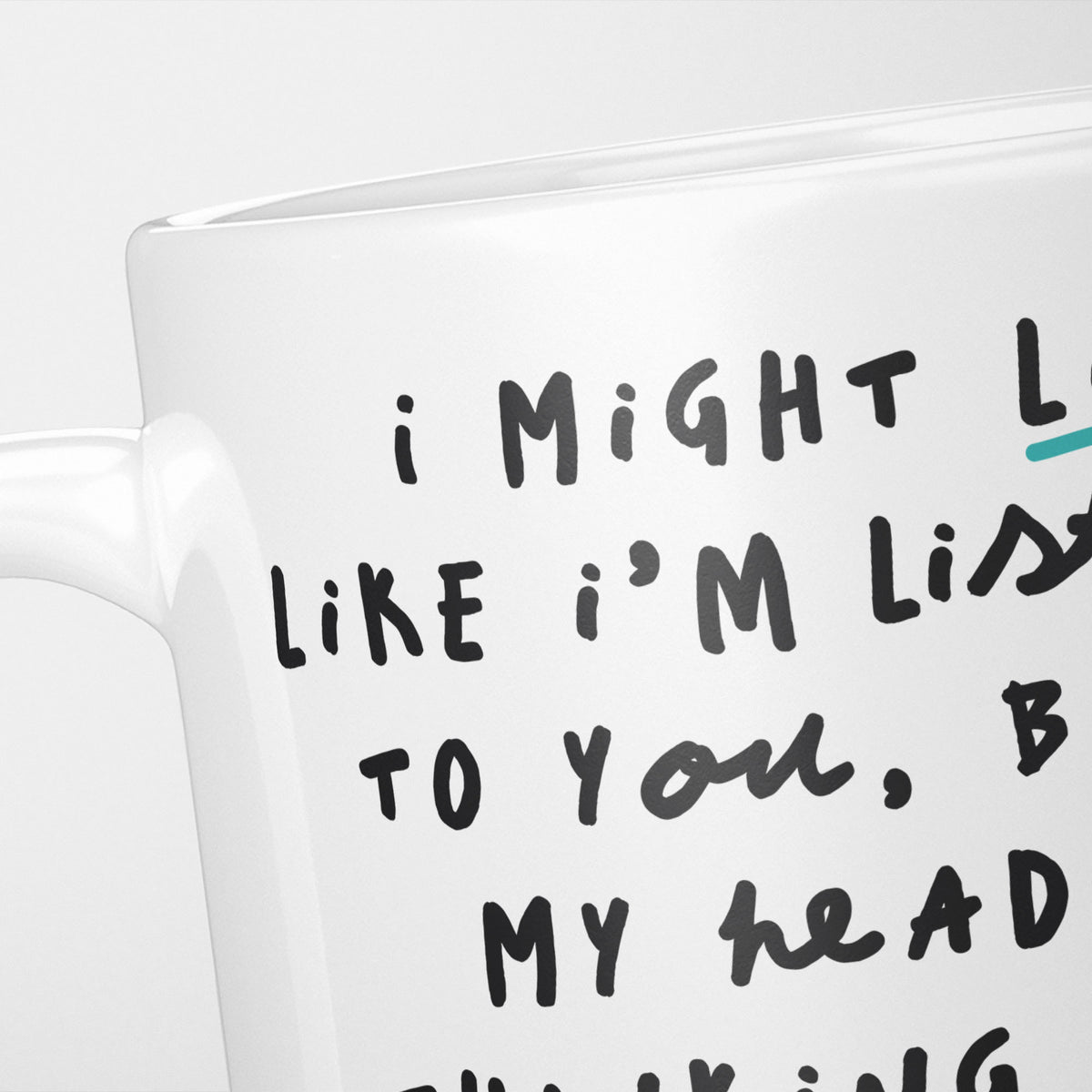 Close crop of the I'm Thinking About Nothing mug, the opening of the hand-lettered text running off the frame, underlined in teal