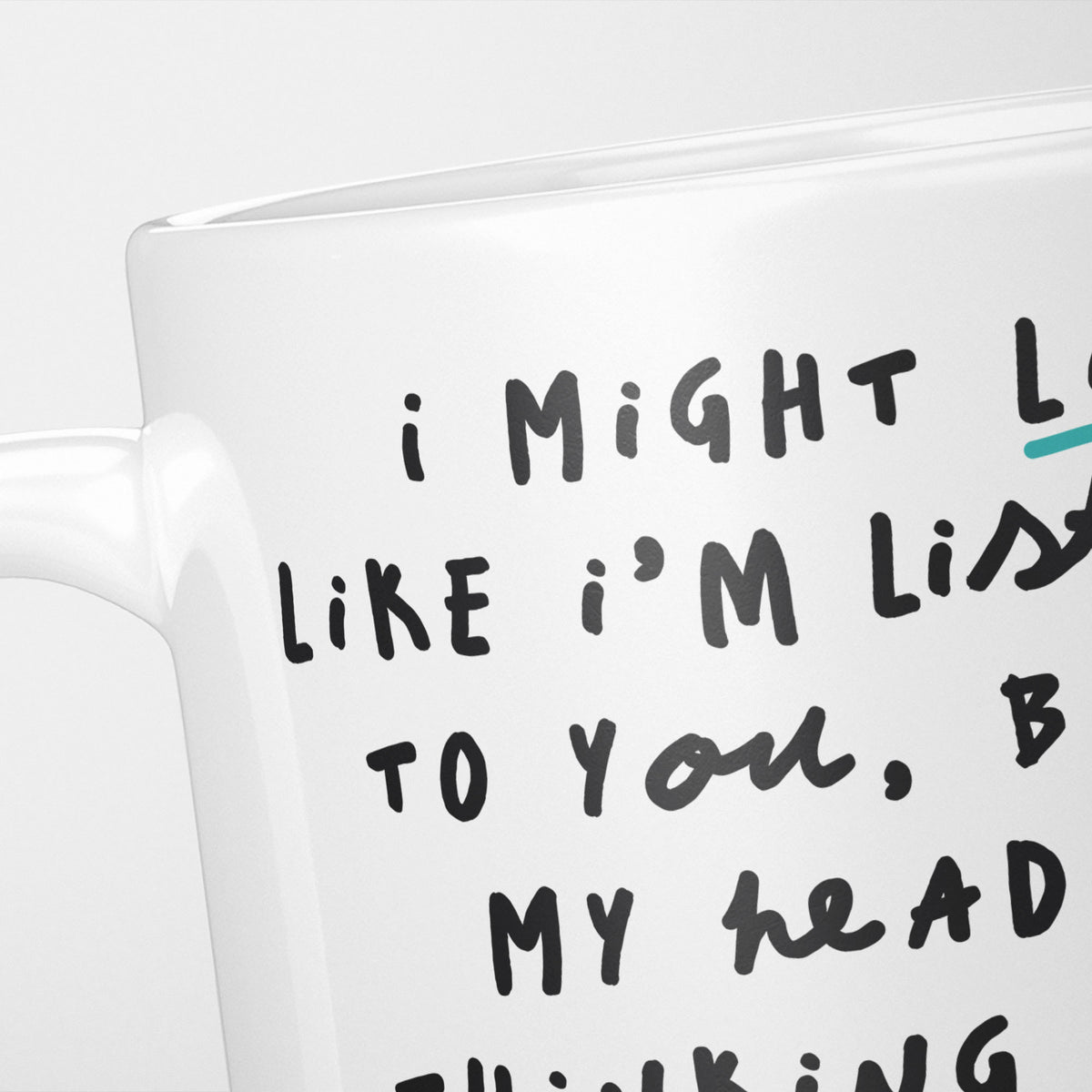Close crop of the I'm Thinking About Raccoons mug, the opening of the hand-lettered text running off the frame, underlined in teal