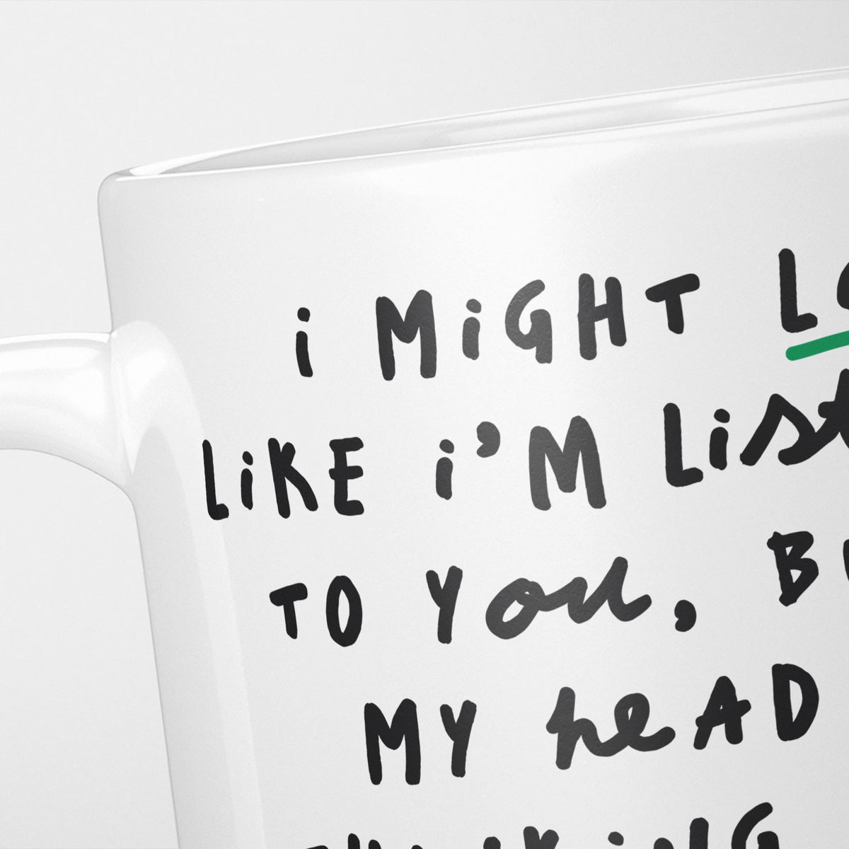 Close crop of the I'm Thinking About Spreadsheets mug, the opening of the hand-lettered text running off the frame, underlined in green