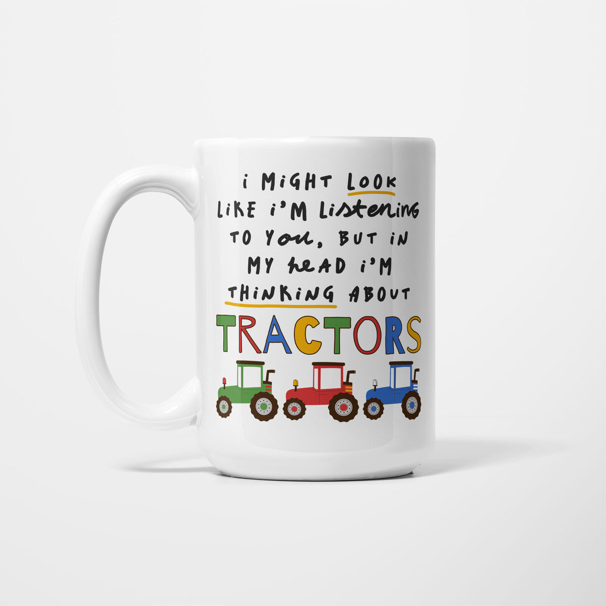 White 15oz ceramic mug, hand-lettered "I might look like I'm listening to you, but in my head I'm thinking about Tractors" in multicoloured capitals with a yellow underline, illustrated with green, red and blue tractors