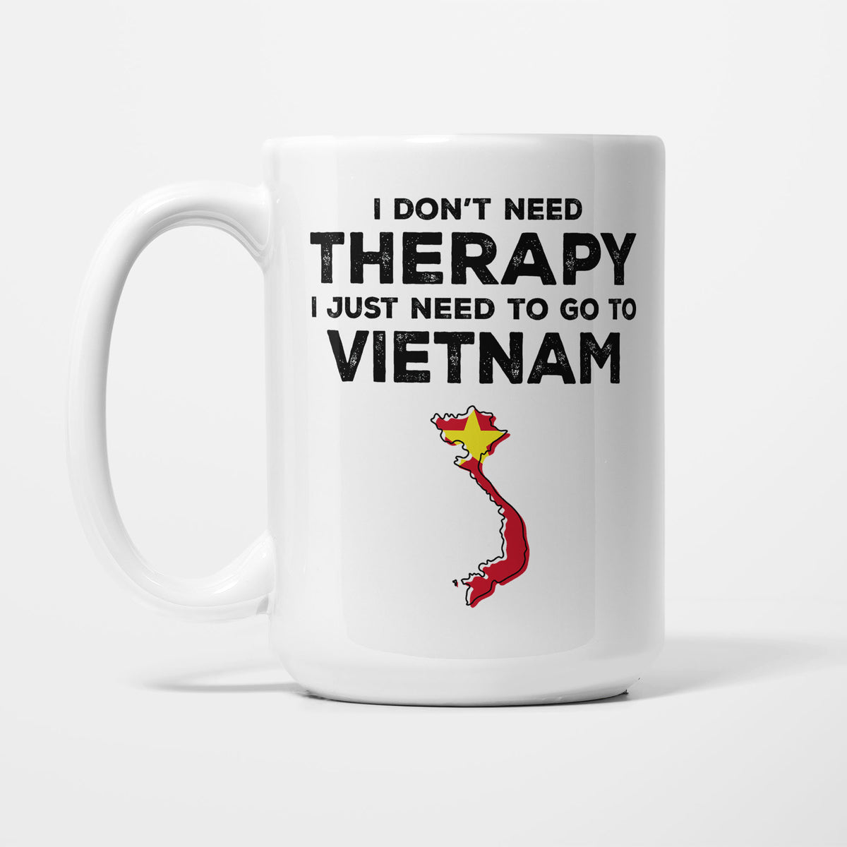 The 15oz I Need Vietnam mug, white ceramic in bold black type reading 'I don't need therapy, I just need to go to VIETNAM', above an outline of Vietnam filled with its national flag