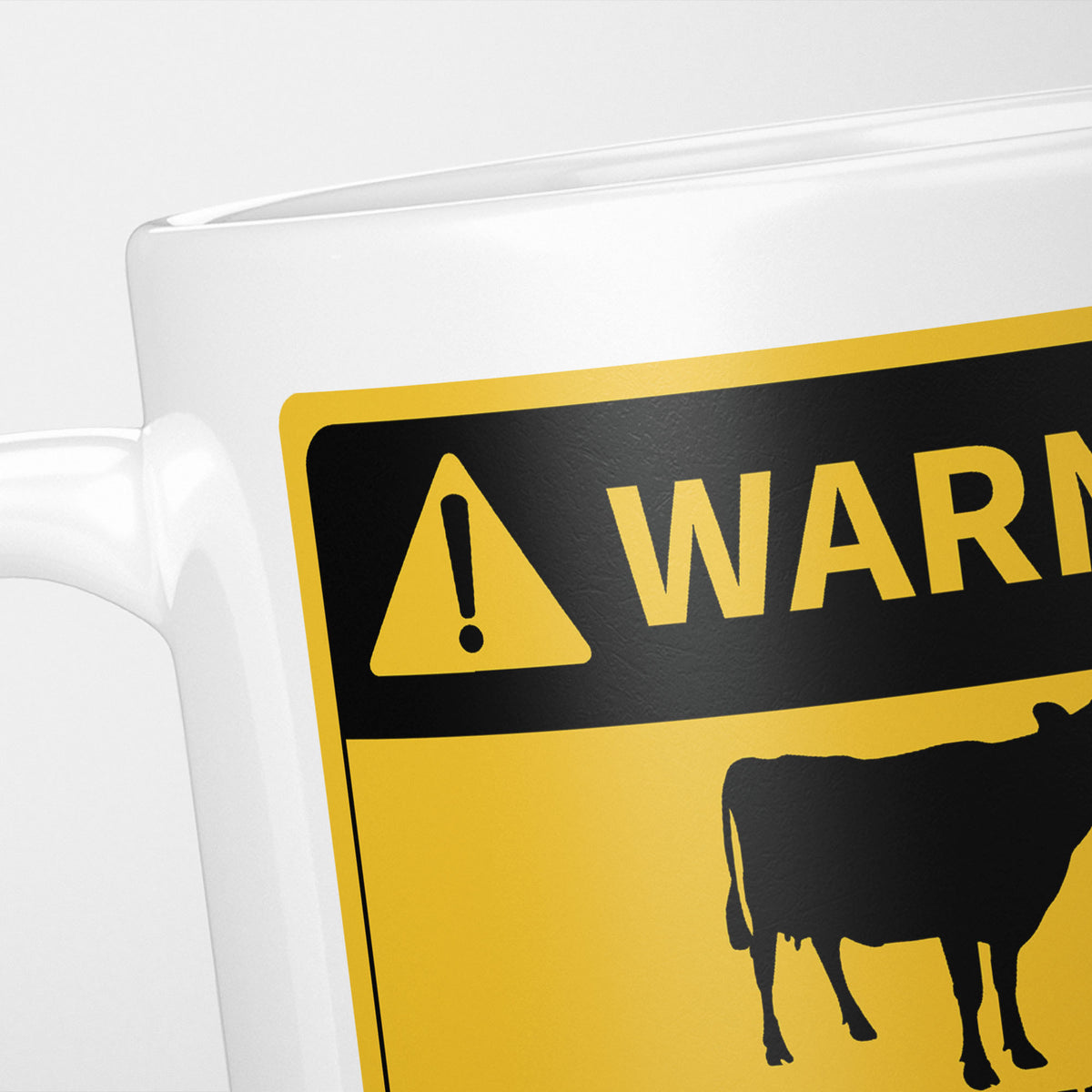 Close crop of the Cows warning sign, the hazard triangle and 'warning' above a cow silhouette
