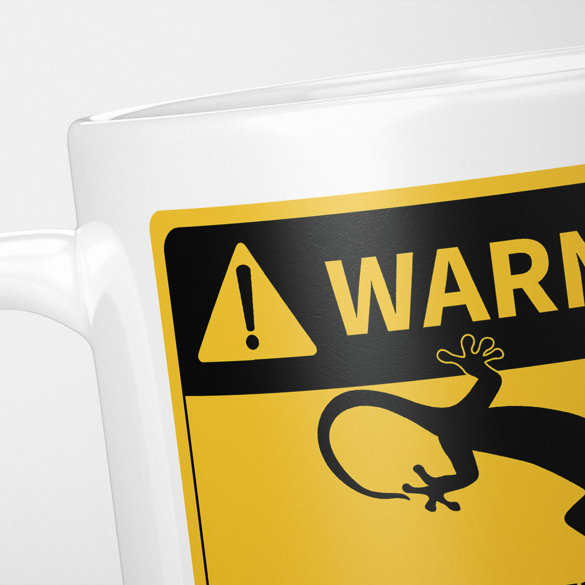 Close crop of the Geckos warning sign, the hazard triangle and 'warning' above a gecko silhouette