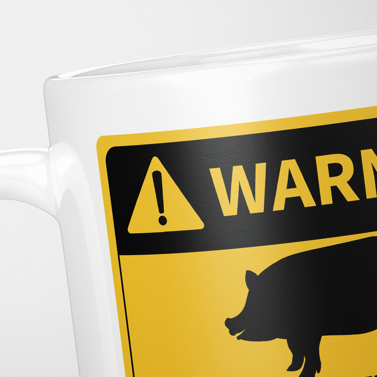 Close crop of the Pigs warning sign, the hazard triangle and 'warning' above a pig silhouette