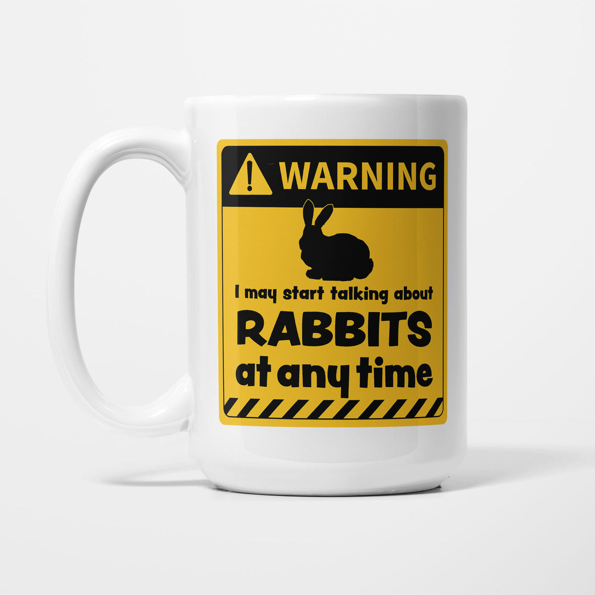 The 15oz Warning mug, white ceramic with a yellow and black warning sign showing a rabbit silhouette above 'I may start talking about Rabbits at any time'