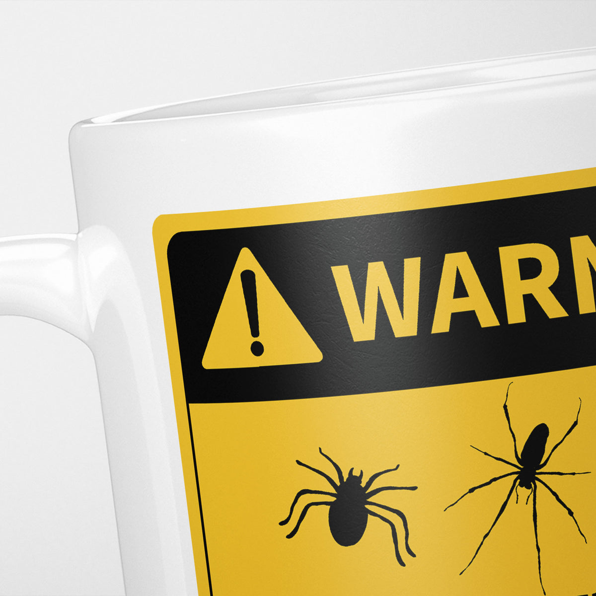 Close crop of the Spiders warning sign, the hazard triangle and 'warning' above three spider silhouettes