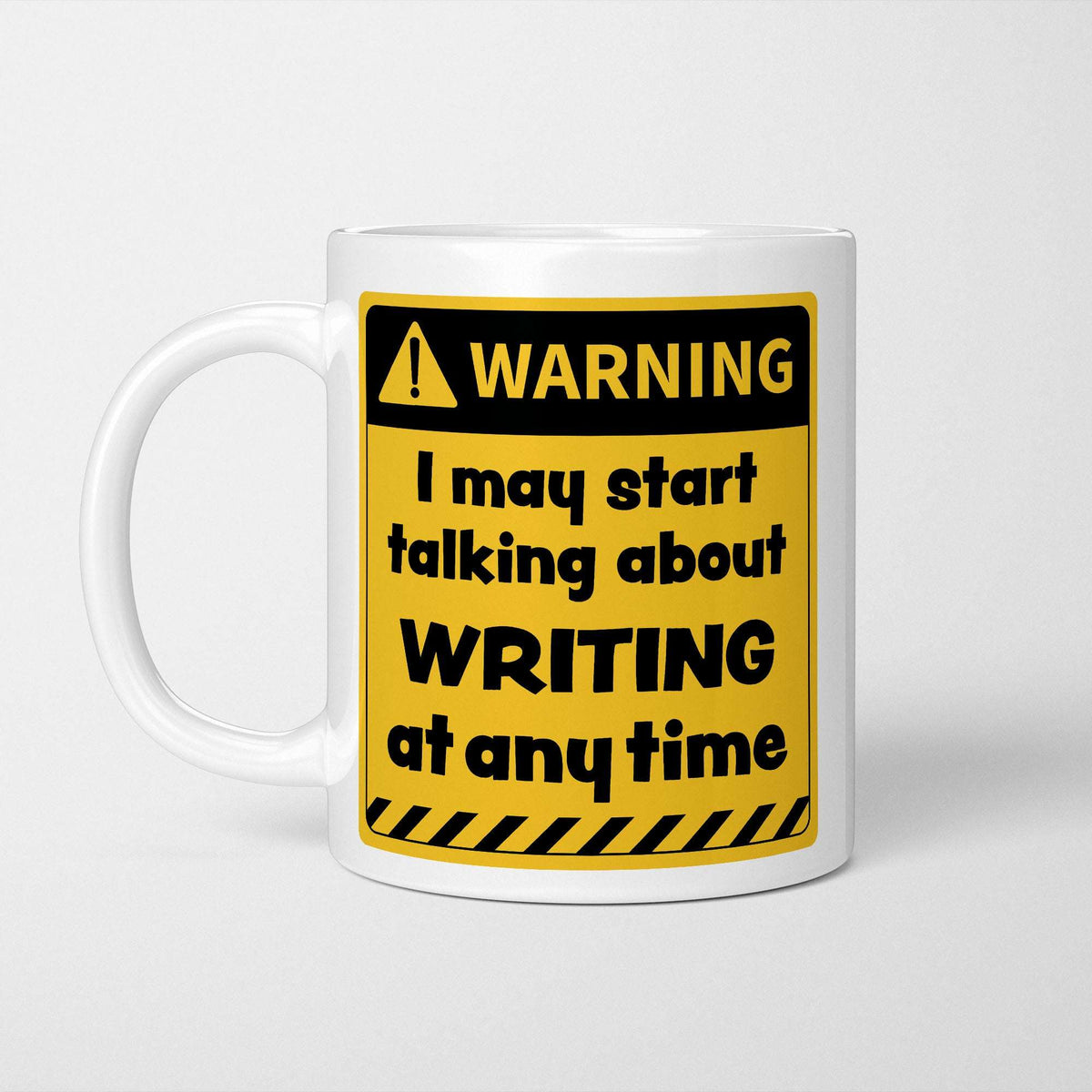 White ceramic mug with a yellow and black warning sign reading 'I may start talking about Writing at any time'