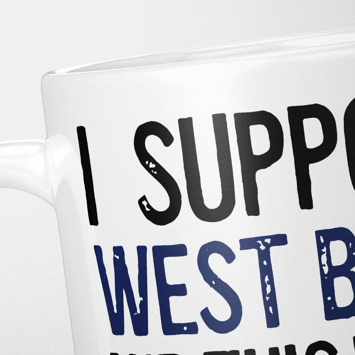 Close crop of the I Support West Brom mug, 'I Support' in heavy black above the club name in navy, running off the edge of the frame