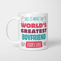 White ceramic mug in retro pink, plum and teal typography reading 'This is what the World's Greatest Boyfriend looks like', with two curved arrows pointing up at the person holding it and starbursts either side