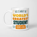 White ceramic mug in retro yellow, orange and dark teal typography reading 'This is what the World's Greatest Student looks like', with two curved arrows pointing up at the person holding it and starbursts either side