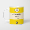 White ceramic mug printed with a vintage-style book cover design reading 'Country Life' by H. E. Bates