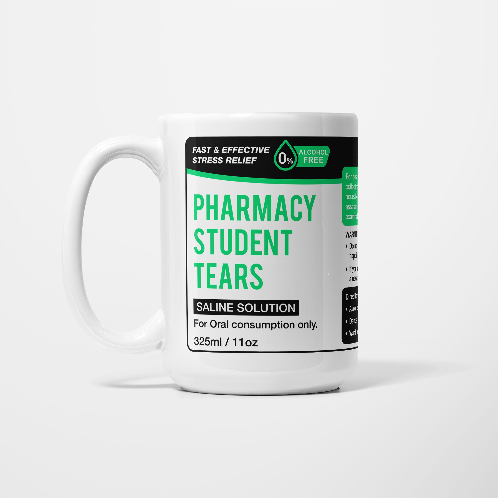 The 15oz Pharmacy Student Tears mug, white ceramic with a black pharmacy-style label reading 'Pharmacy Student Tears — Saline Solution, for oral consumption only'