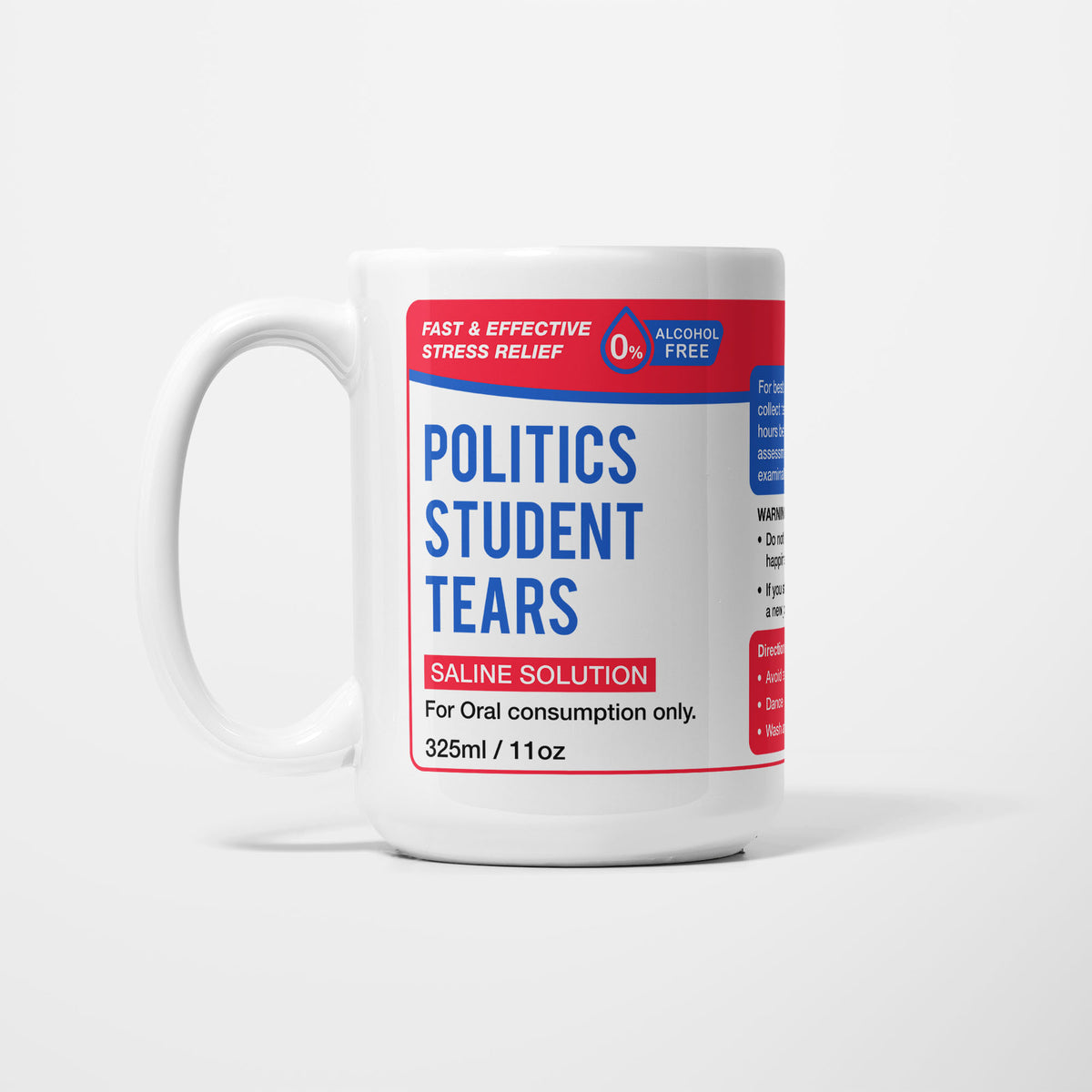 The 15oz Politics Student Tears mug, white ceramic with a red pharmacy-style label reading 'Politics Student Tears — Saline Solution, for oral consumption only'