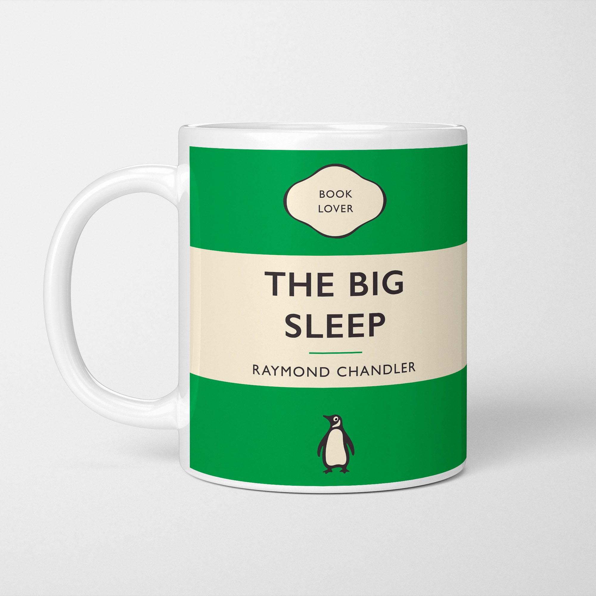 White ceramic mug printed with a vintage-style book cover design reading 'The Big Sleep' by Raymond Chandler
