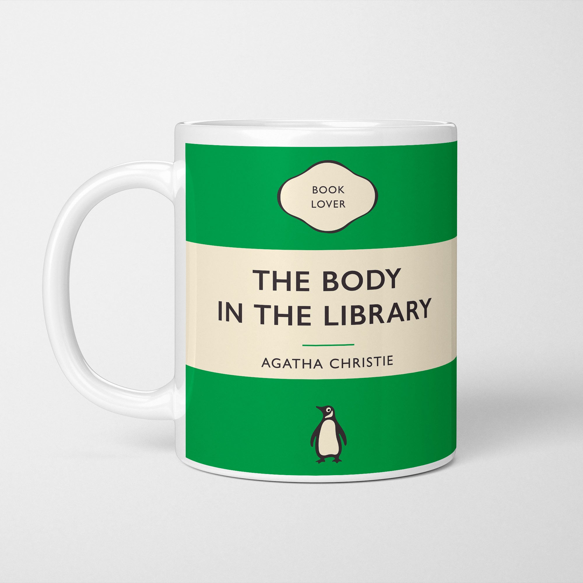 White ceramic mug printed with a vintage-style book cover design reading 'The Body in the Library' by Agatha Christie