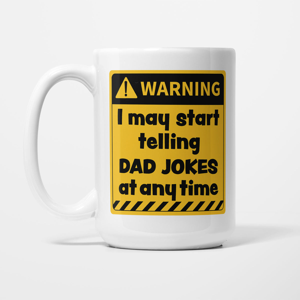 The 15oz Warning mug, white ceramic with a yellow and black warning sign reading 'I may start telling dad jokes at any time'