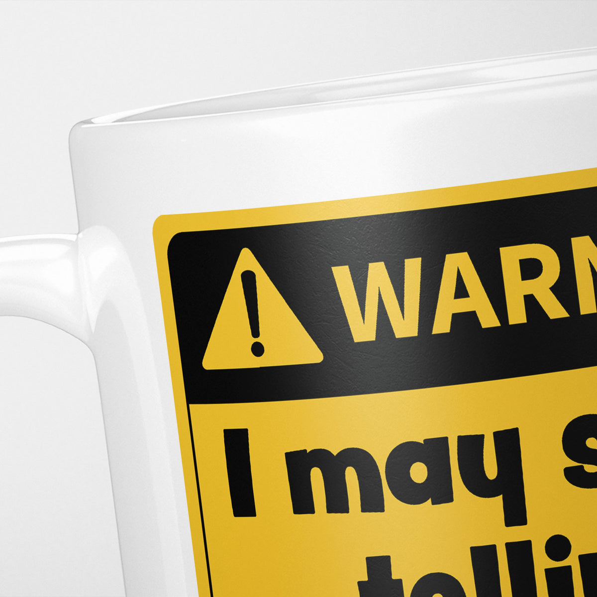 Close crop of the warning sign, the hazard triangle and 'warning' above 'I may start telling', the rest of the line cropped out of frame